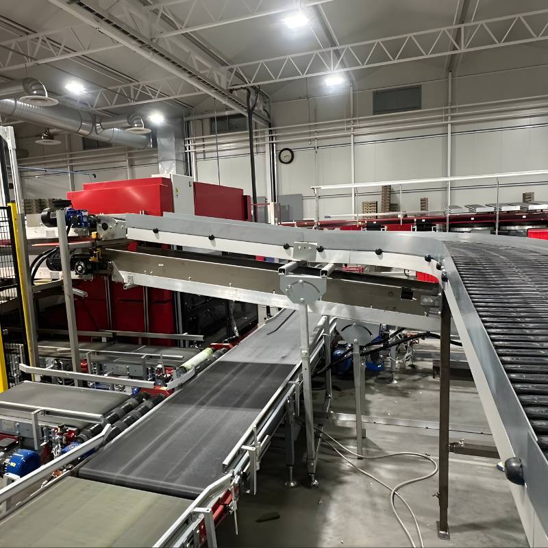 Straight motorized roller conveyor system installed and leveled in a distribution center.